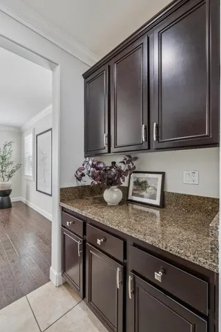 a kitchen with a dining table chairs and view of living room
