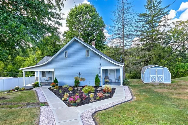 a view of a house with backyard and sitting area