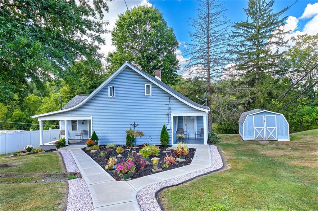 a view of a house with backyard and sitting area