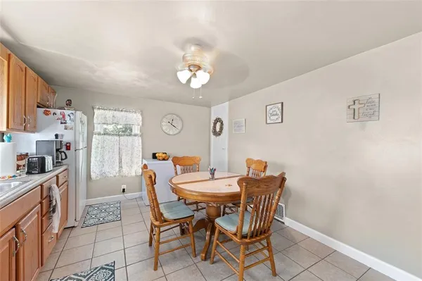 a view of a dining room with furniture and a chandelier