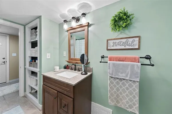 a bathroom with a sink a mirror and a shower