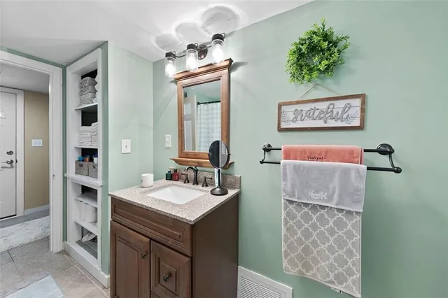 a bathroom with a sink a mirror and a shower