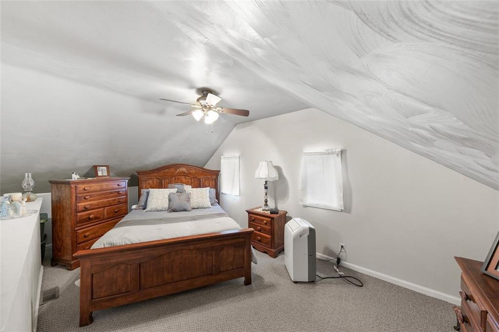 199 Water Street Dickerson Run, PA 15430 - Photo 20 of 22 a bedroom with a bed and a chandelier