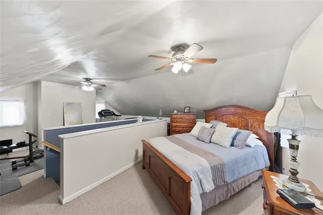 a bedroom with bed and a chandelier