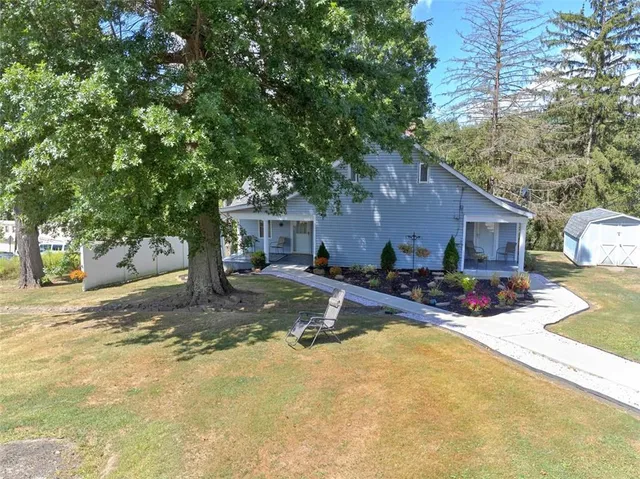 a view of a house with snow on the tree