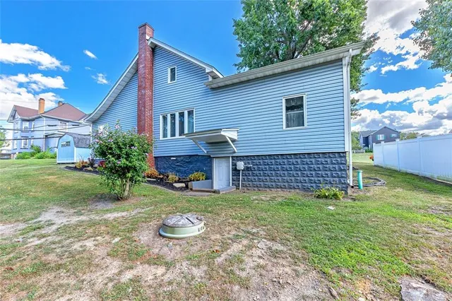 a view of a house with a yard and sitting area