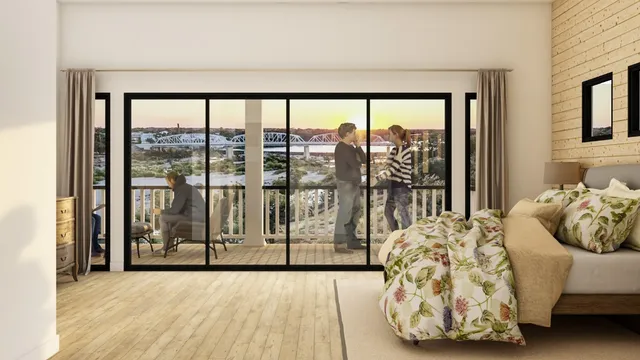 a living room filled with furniture and a large window