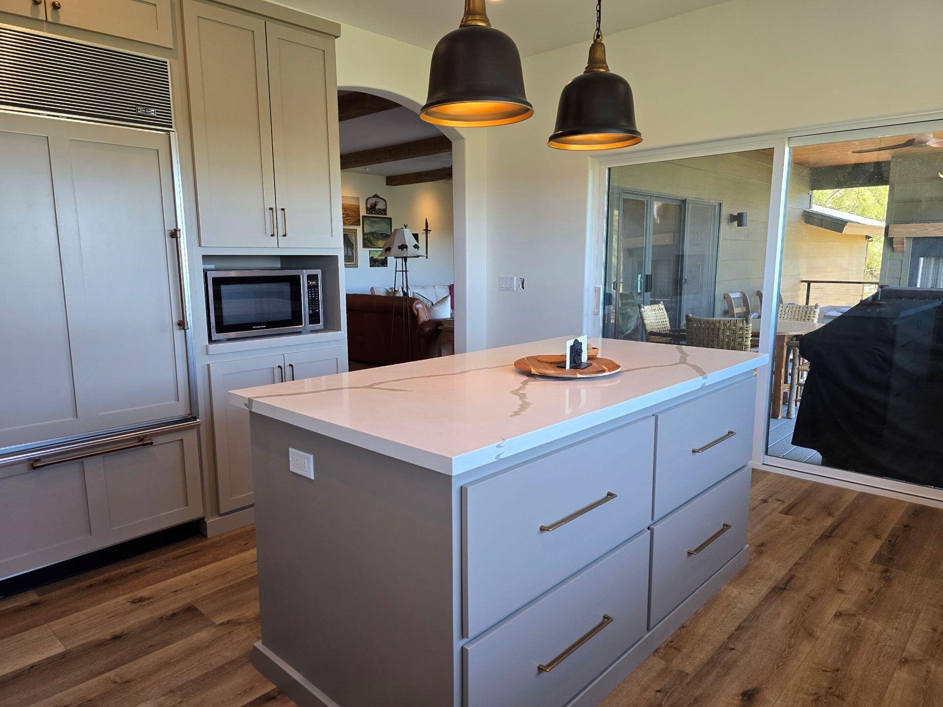 240 Rockinghorse Bend Road Payson, AZ 85541 - Photo 12 of 53 a kitchen with stainless steel appliances granite countertop a sink a microwave oven and a dining table with wooden floor
