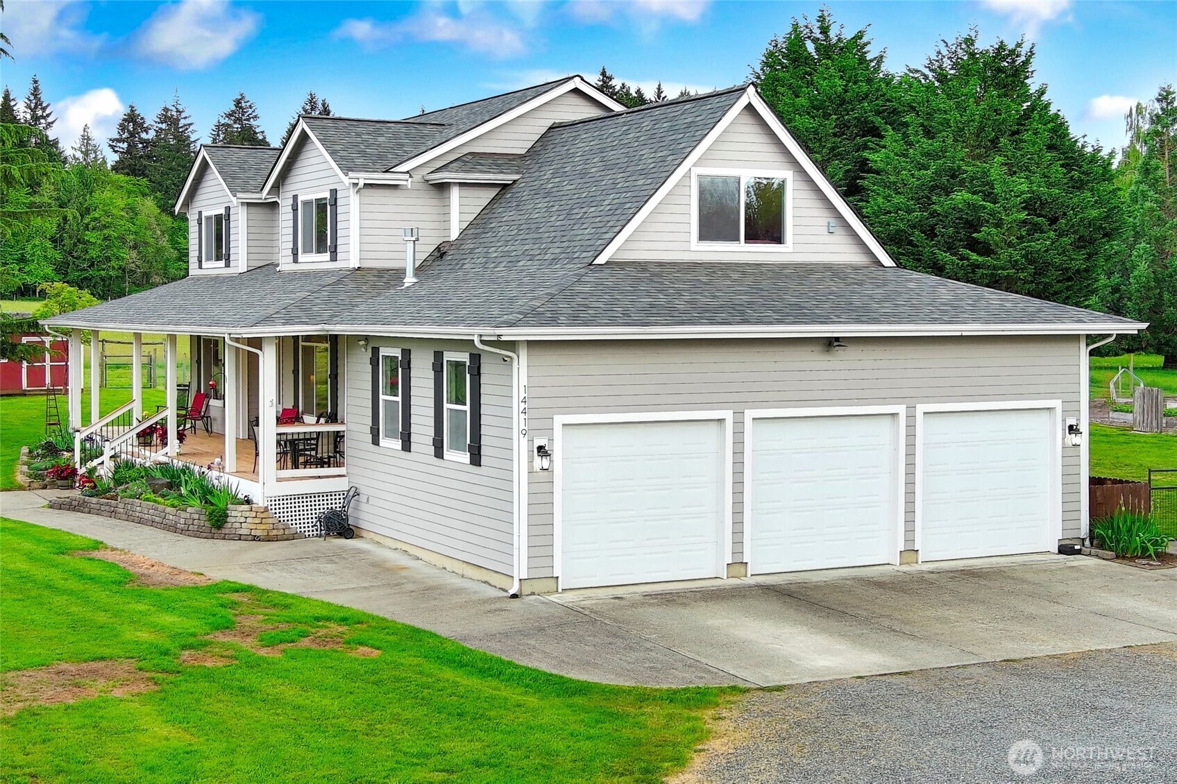 14419 Martinson Road Southeast Yelm, WA 98597 - Photo 2 of 39 a front view of a house with a garden