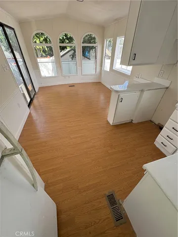 a view of kitchen with microwave and cabinets