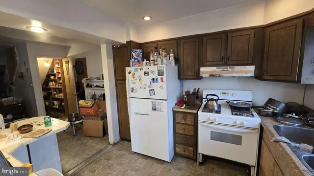 a kitchen with refrigerator and cabinets