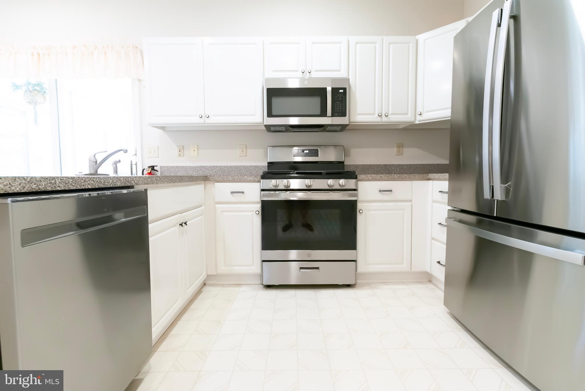 89 Lantern Lane Columbus, NJ 08022 - Photo 15 of 55 a kitchen with stainless steel appliances a stove sink and microwave