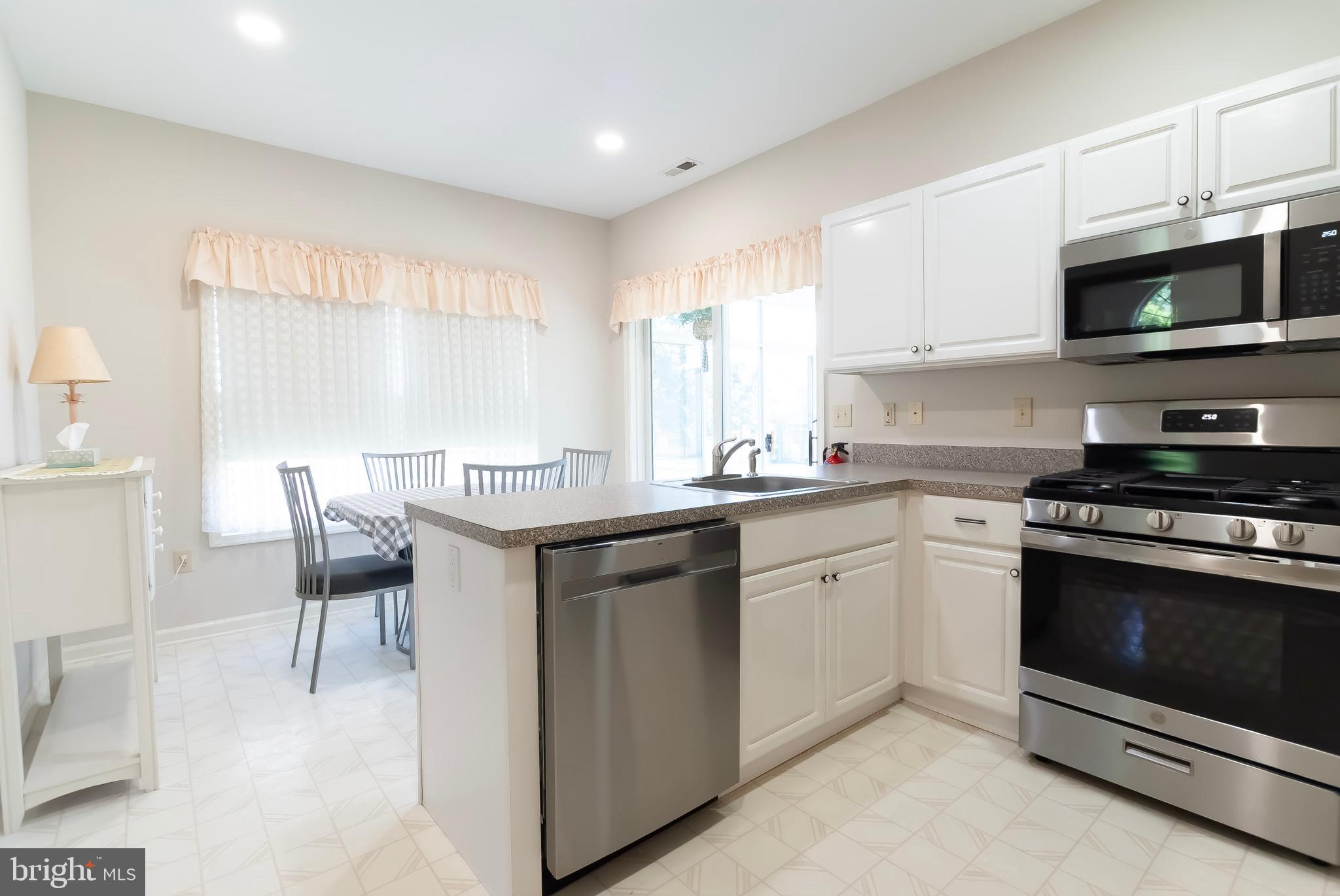 89 Lantern Lane Columbus, NJ 08022 - Photo 17 of 55 a kitchen with stainless steel appliances granite countertop a stove a sink and a microwave