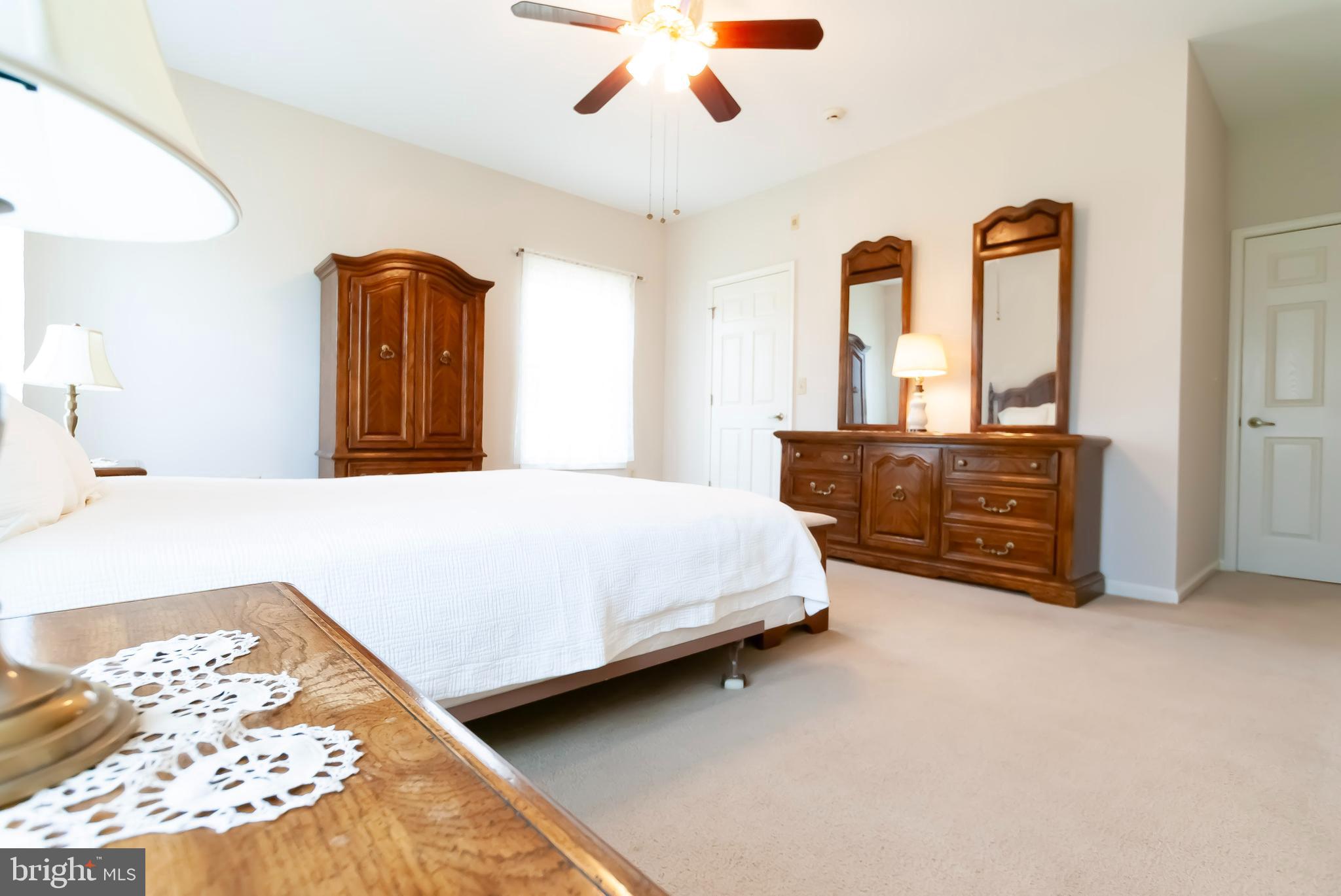 89 Lantern Lane Columbus, NJ 08022 - Photo 21 of 55 a spacious bedroom with a bed a dresser and a chandelier