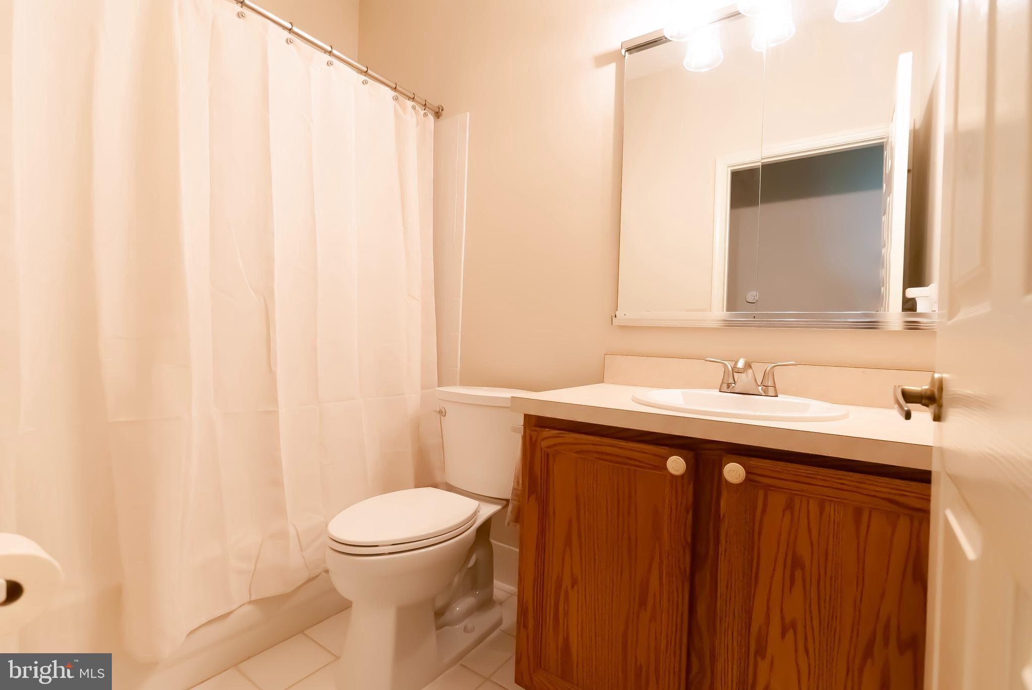 89 Lantern Lane Columbus, NJ 08022 - Photo 31 of 55 a bathroom with a sink a toilet and a mirror