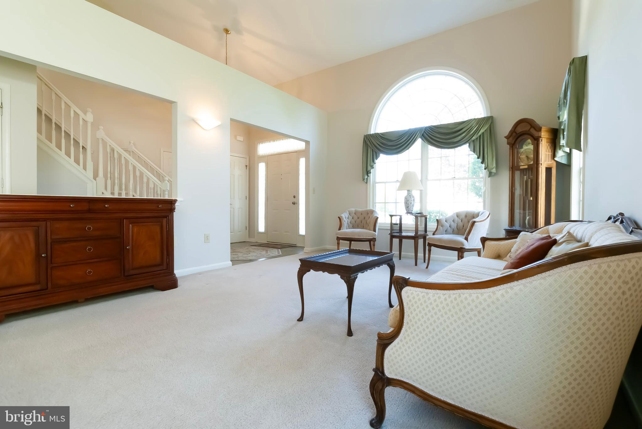 89 Lantern Lane Columbus, NJ 08022 - Photo 9 of 55 a living room with furniture a large window and a chandelier