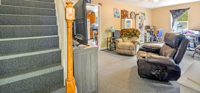 a living room with furniture and a floor to ceiling window