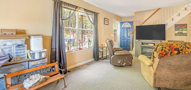 a bedroom with furniture and a flat screen tv