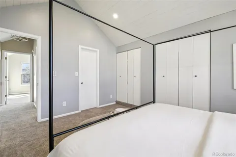 a bathroom with a granite countertop sink a toilet and shower