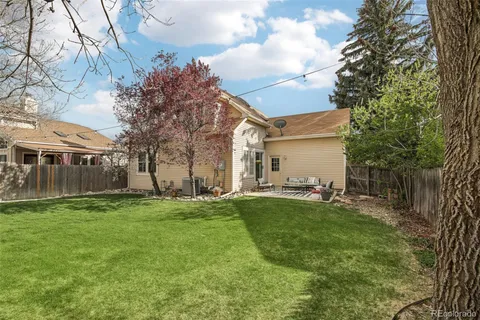 a backyard of a house with table and chairs