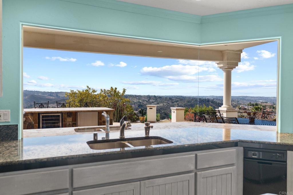1402 Vista De Lomas Bonsall, CA 92003 - Photo 17 of 56 a kitchen with a sink and a large window