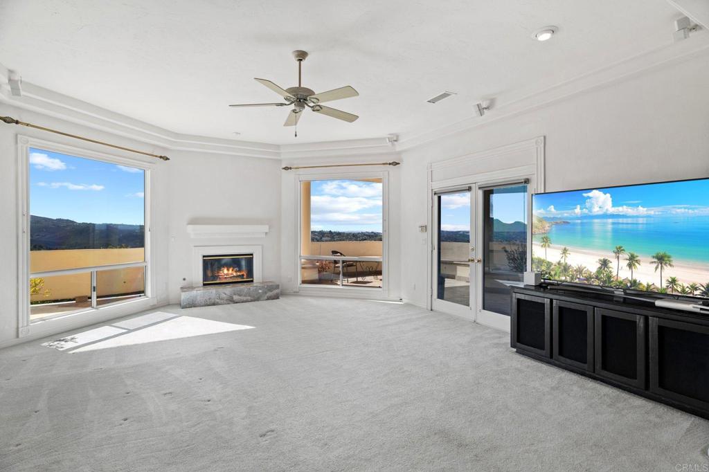 1402 Vista De Lomas Bonsall, CA 92003 - Photo 20 of 56 a large white kitchen with a large window and a fireplace