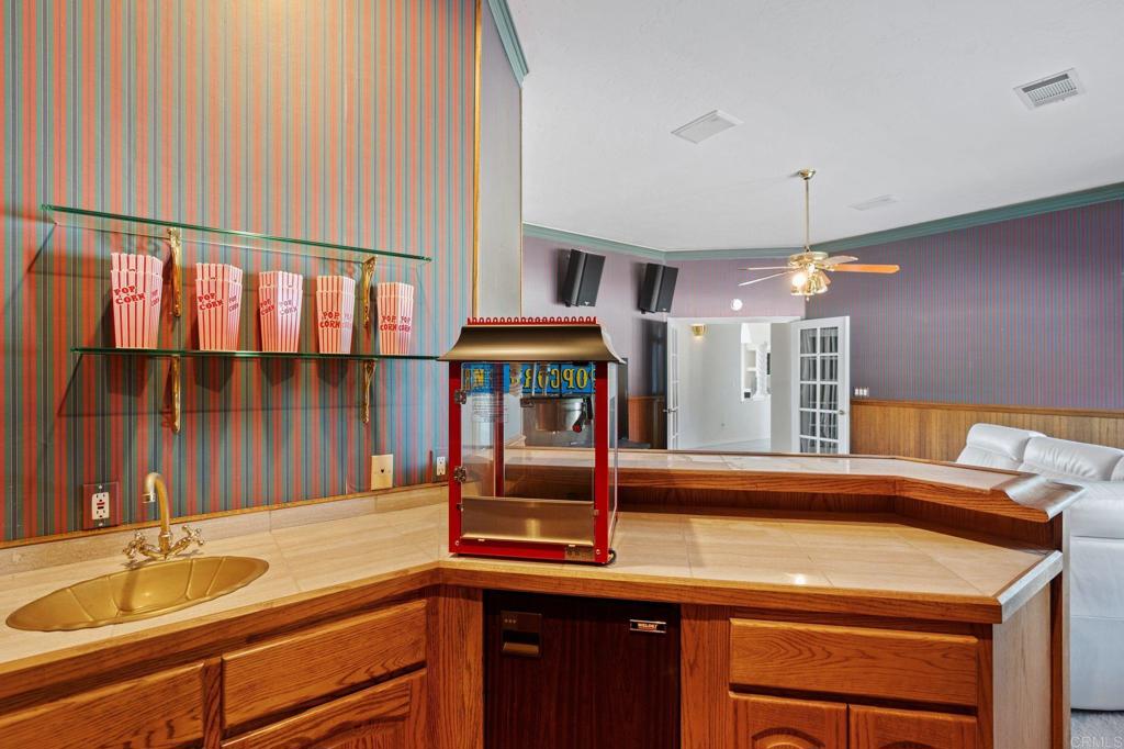 1402 Vista De Lomas Bonsall, CA 92003 - Photo 31 of 56 a kitchen with a sink and a refrigerator