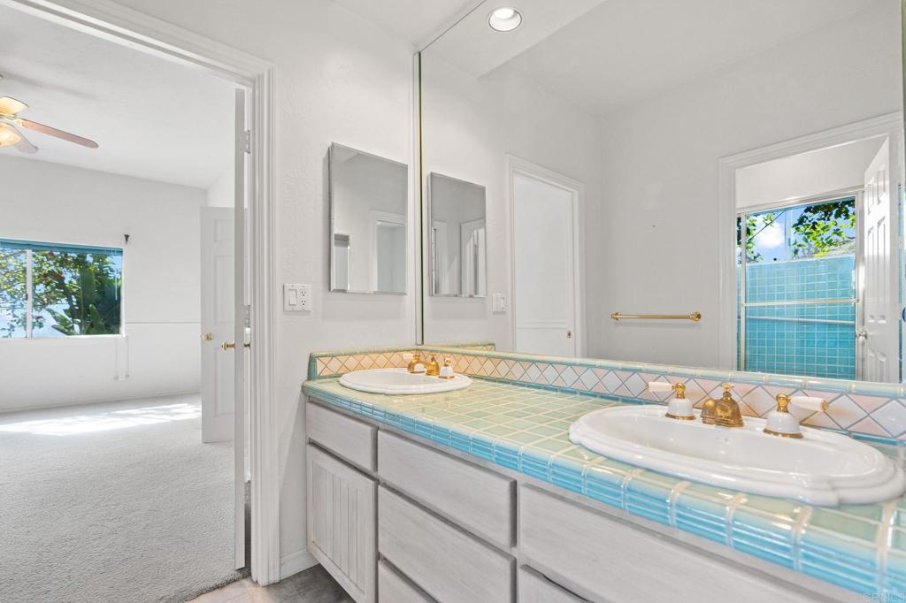 1402 Vista De Lomas Bonsall, CA 92003 - Photo 34 of 56 a bathroom with a granite countertop sink and a mirror
