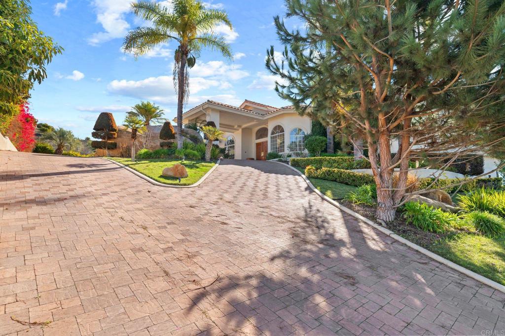 1402 Vista De Lomas Bonsall, CA 92003 - Photo 4 of 56 a view of a white house with a yard and potted plants