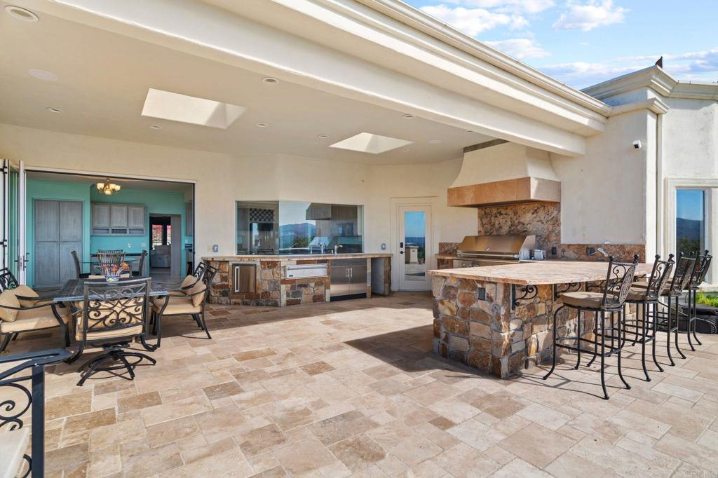 1402 Vista De Lomas Bonsall, CA 92003 - Photo 42 of 56 a view of kitchen with kitchen island dining table and chairs