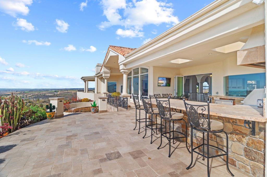 1402 Vista De Lomas Bonsall, CA 92003 - Photo 43 of 56 a view of a patio with dining table and chairs with wooden fence