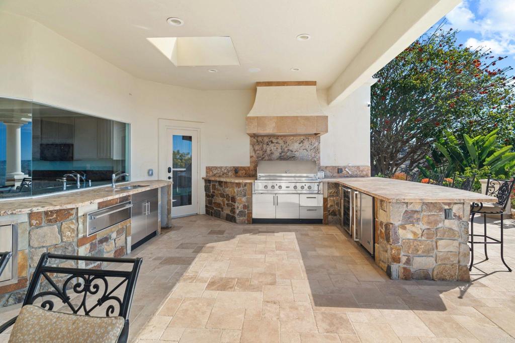 1402 Vista De Lomas Bonsall, CA 92003 - Photo 44 of 56 a kitchen with stainless steel appliances a stove top oven a sink a dining table and chairs