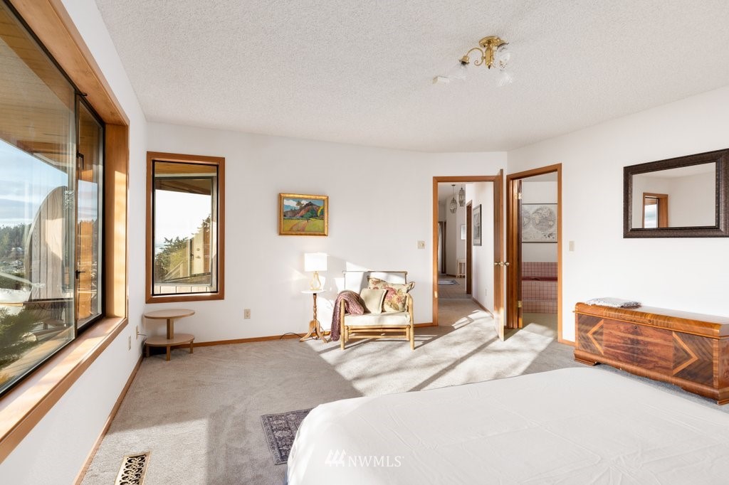 1860 East Hunskor Road Oak Harbor, WA 98277 - Photo 22 of 40 a bedroom with a bed and large windows