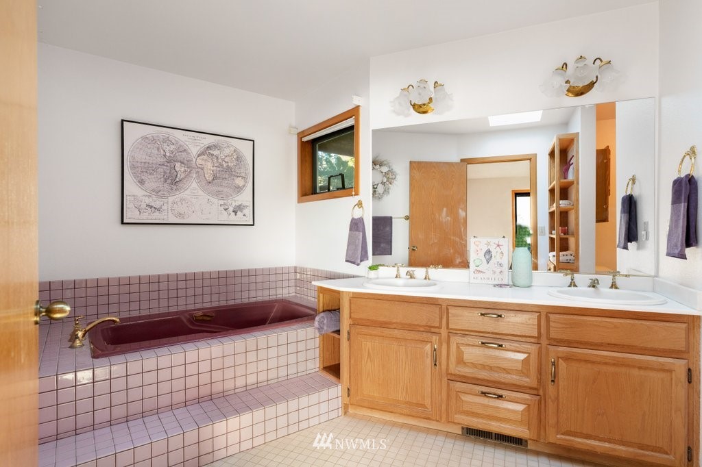 1860 East Hunskor Road Oak Harbor, WA 98277 - Photo 23 of 40 a bathroom with a sink a vanity and a mirror