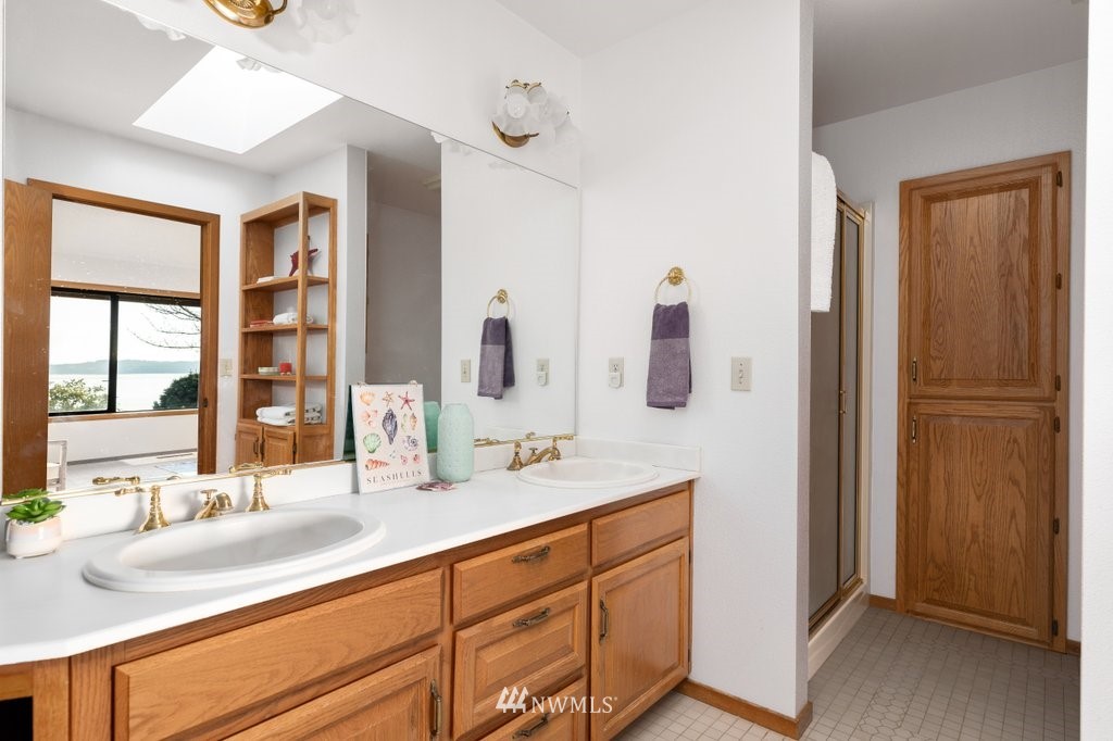 1860 East Hunskor Road Oak Harbor, WA 98277 - Photo 24 of 40 a bathroom with a double vanity sink and mirror