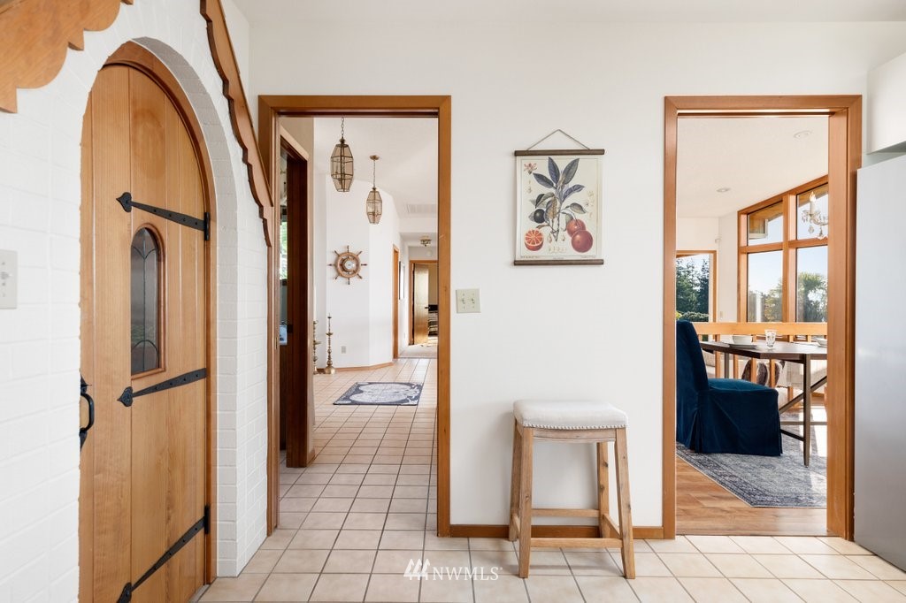 1860 East Hunskor Road Oak Harbor, WA 98277 - Photo 27 of 40 a view of a hallway to a livingroom with furniture and a window
