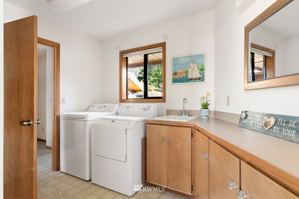 1860 East Hunskor Road Oak Harbor, WA 98277 - Photo 29 of 40 a utility room with cabinets dryer and washer