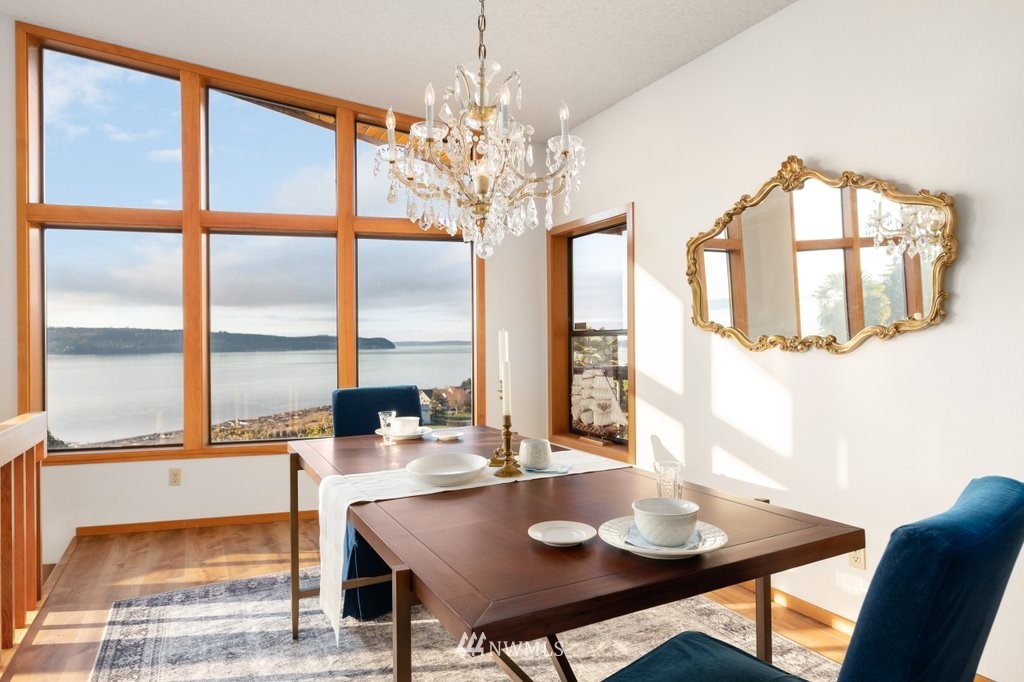 1860 East Hunskor Road Oak Harbor, WA 98277 - Photo 8 of 40 a dining room with furniture a large window and a chandelier