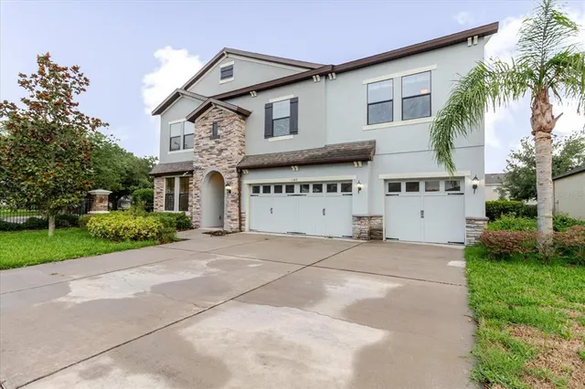 a front view of a house with a yard and garage