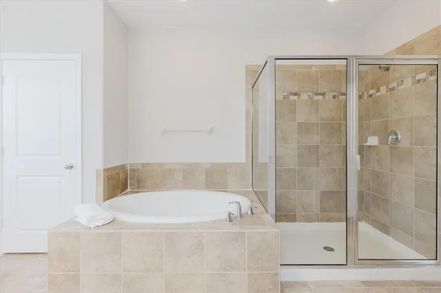 an aerial view of residential houses with outdoor space and trees