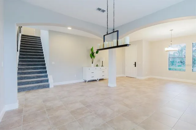 a kitchen with stainless steel appliances kitchen island granite countertop a sink a stove and a refrigerator