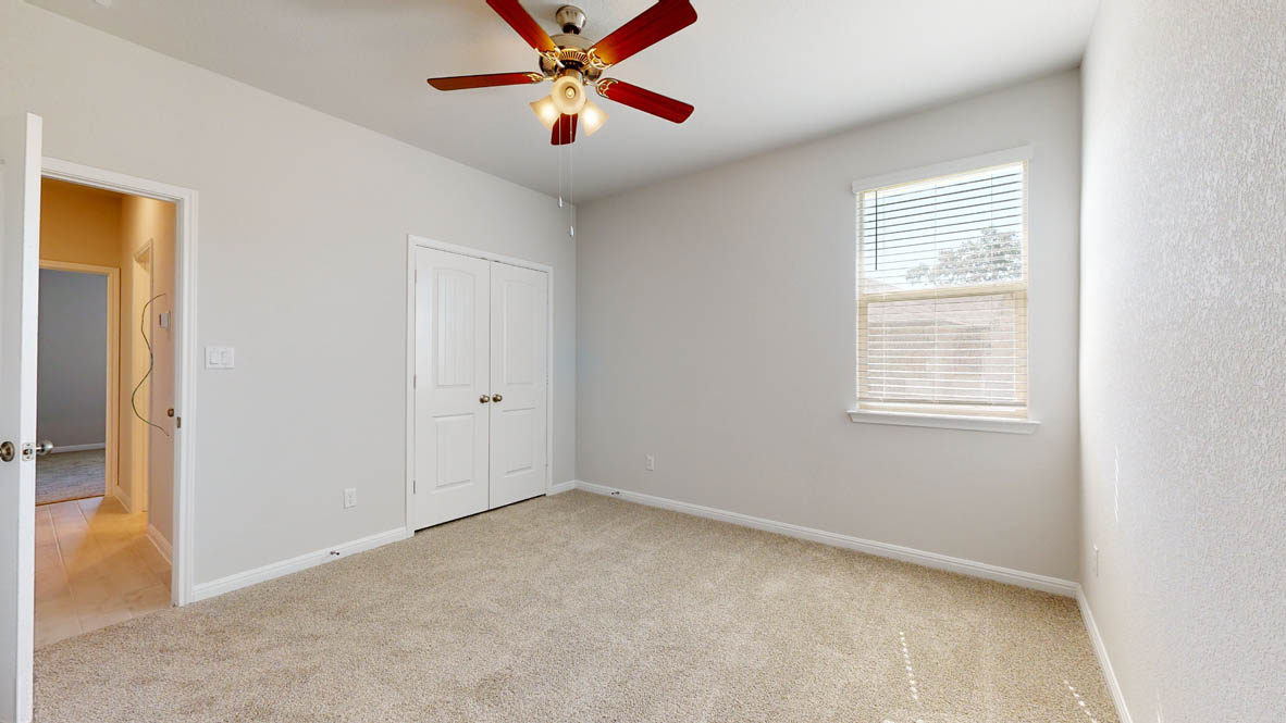 808 Gauge Road Thorndale, TX 76577 - Photo 16 of 31 A quiet bedroom featuring plush carpeting, a single window, and a ceiling fan for comfort.