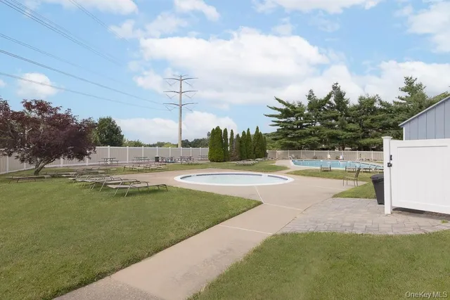 a view of a swimming pool with a yard