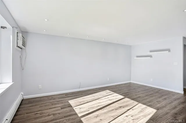 a view of a kitchen with wooden floor and a large window