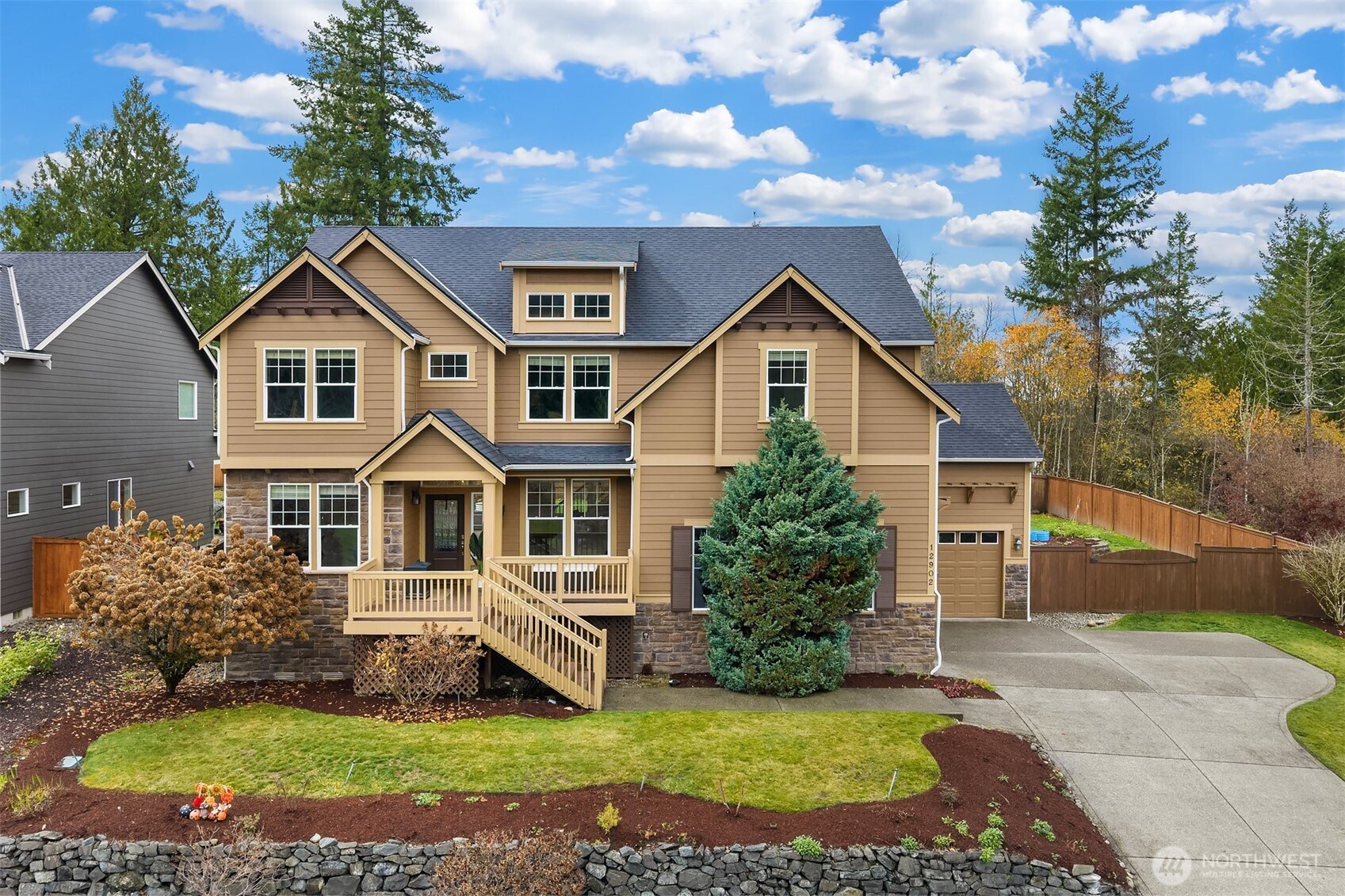 12902 194th Ave Court East Bonney Lake, WA 98391 - Photo 1 of 40 a front view of a house with a garden and trees
