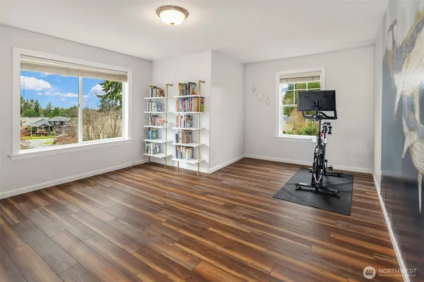 a view of a livingroom with furniture wooden floor and a window