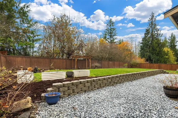 a view of a yard with wooden fence