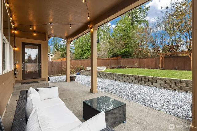 a view of a patio with couches table and chairs and potted plants