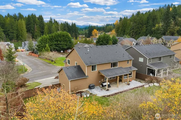an aerial view of a house with swimming pool and a yard