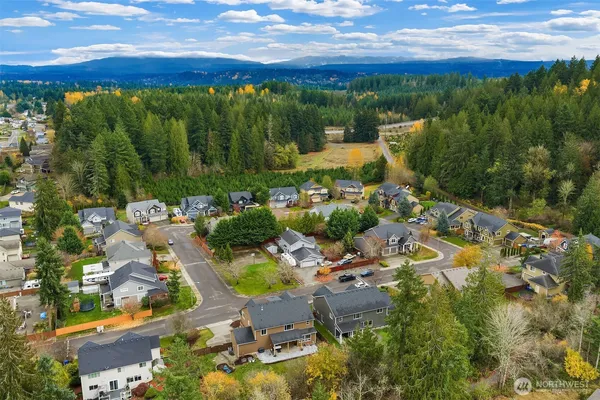 an aerial view of a houses with a yard